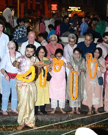 Welcoming a pilgrim group with marigold garlands