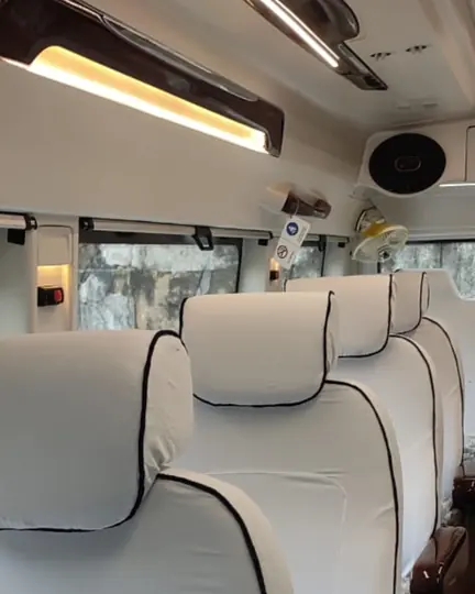 Comfortable push-back seats inside the Tempo Traveller